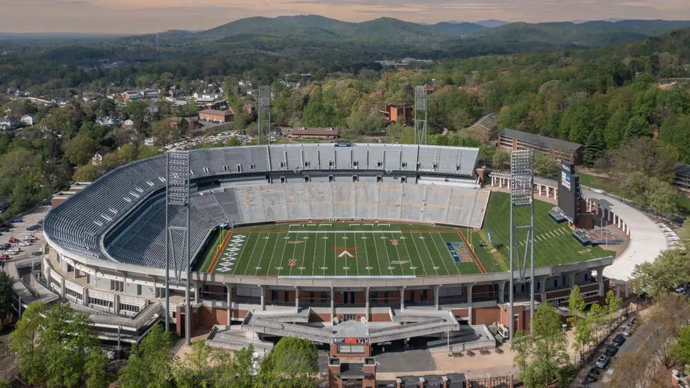 Aerial view of football stadium with mountains the background