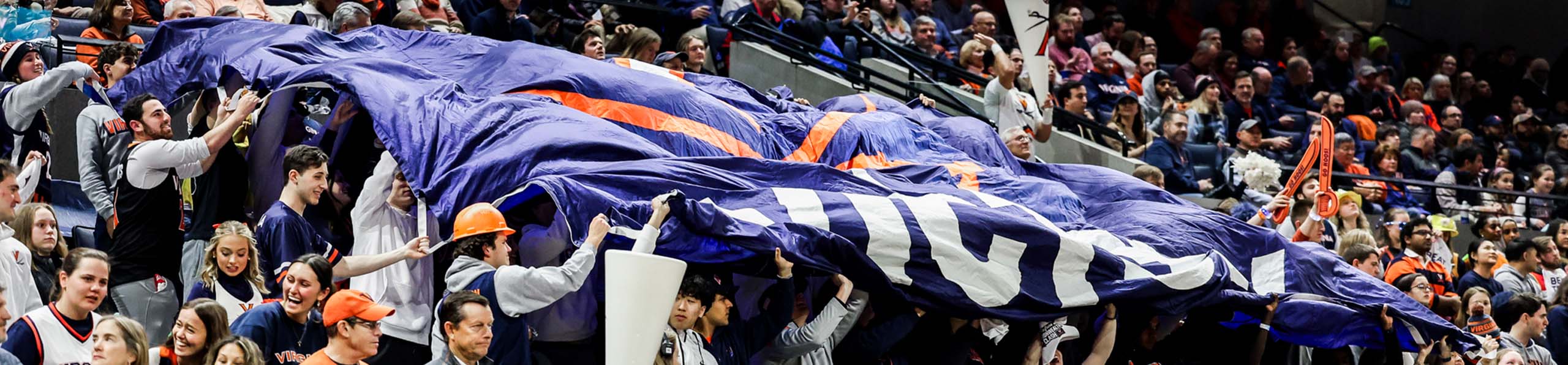 fans in the stands with a giant flag