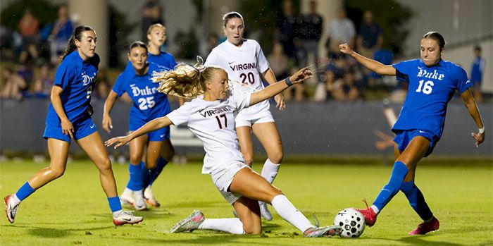 UVA soccer player sliding for the ball during a match