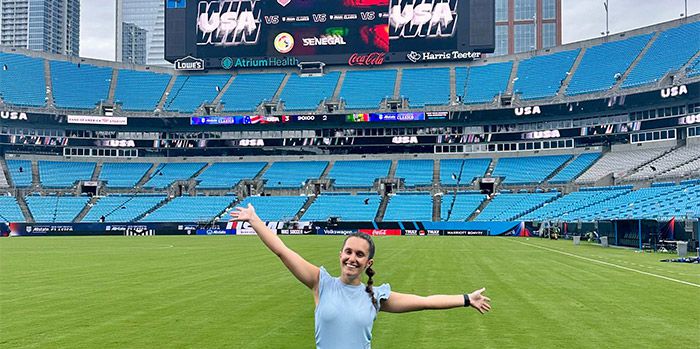 UVA alumna on the field at the World Cup stadium