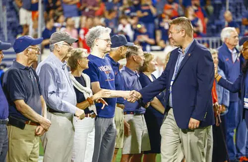 Man shaking hands with a row of people